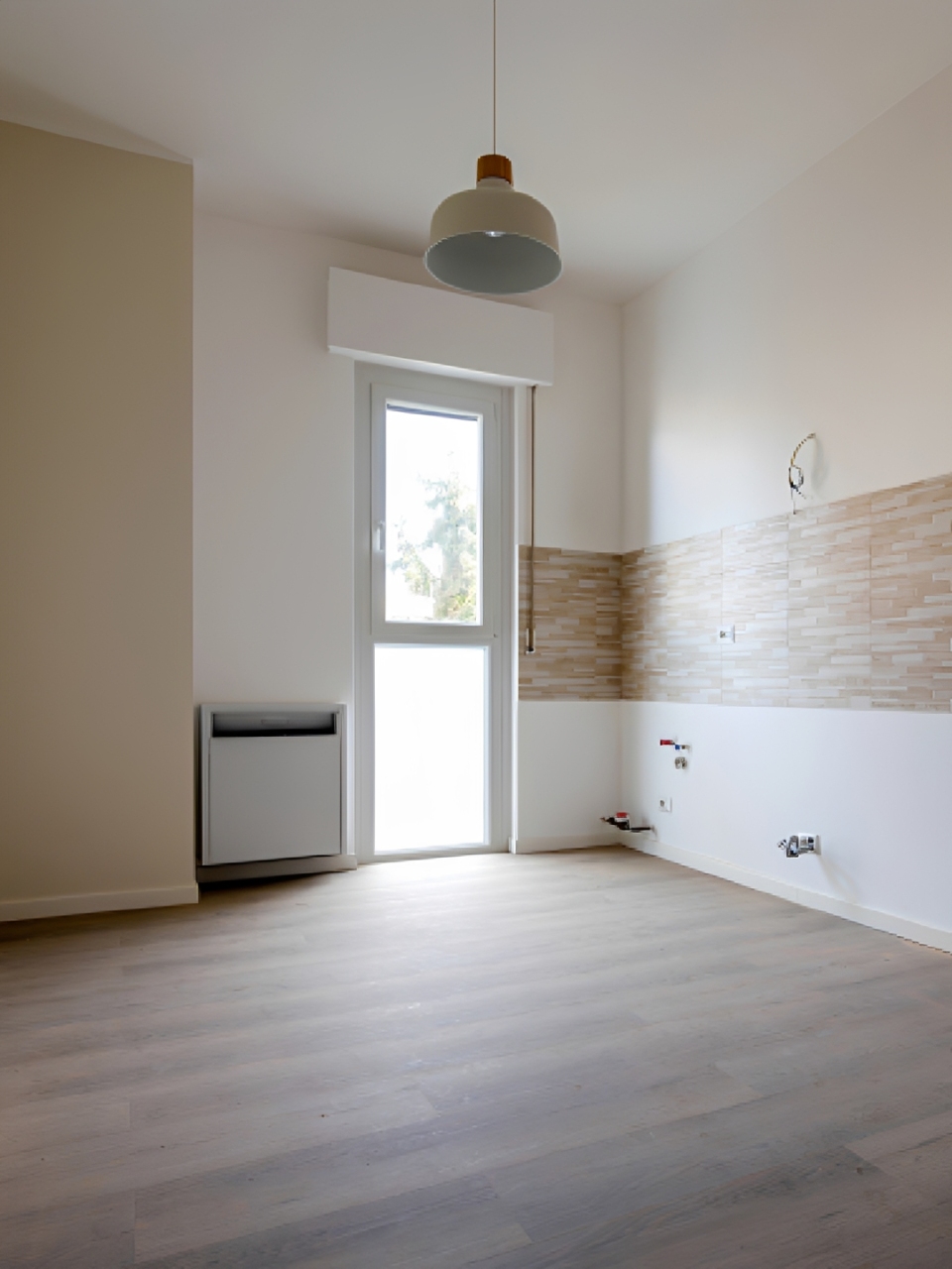 Empty room with wooden floor and window.