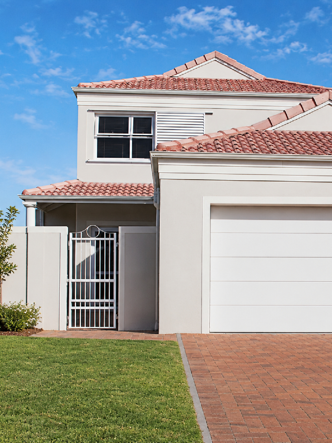 Modern house with red roof and garage.